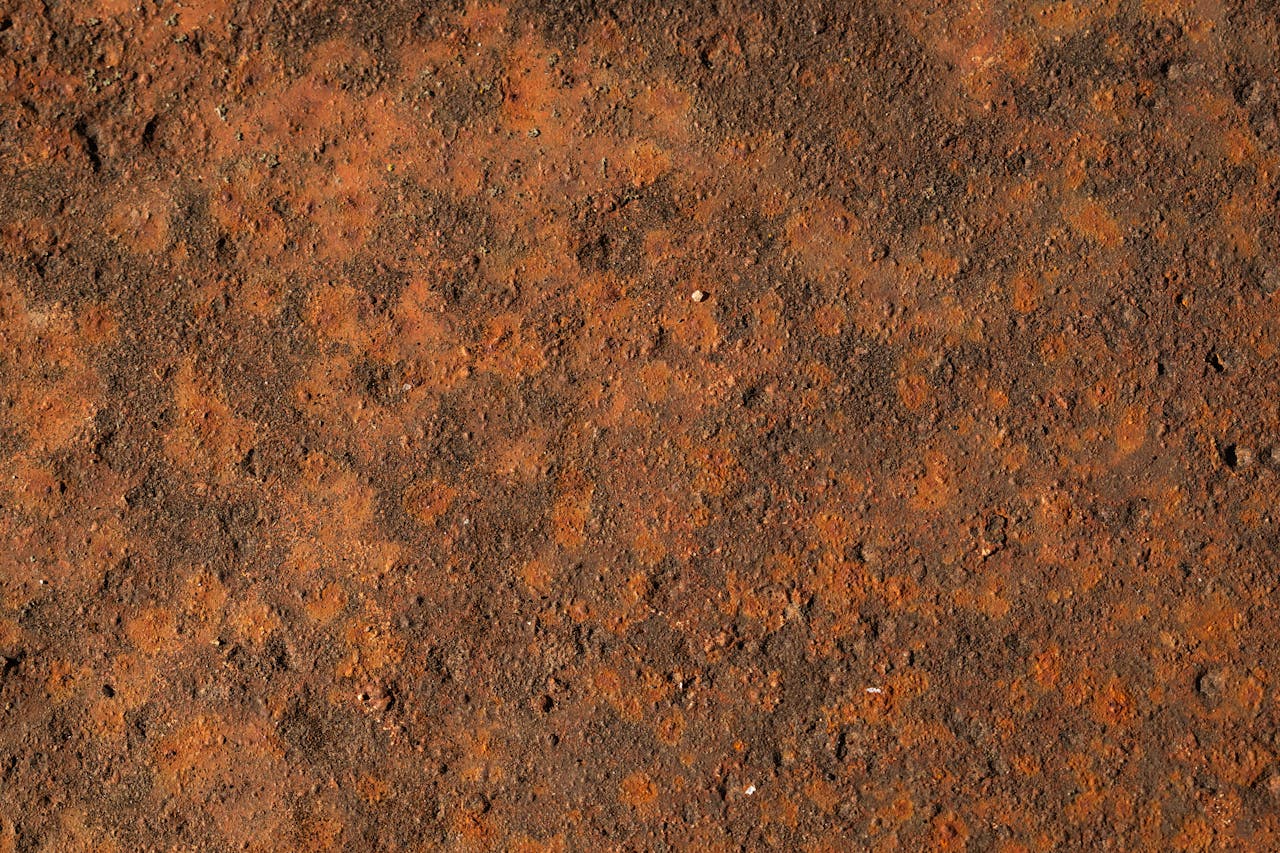 ours-journey Detailed close-up of a rusty metal surface showing corrosion and texture.