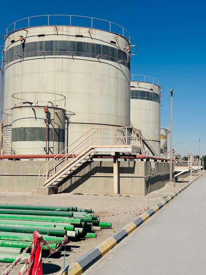 Storage tanks in Saudi Arabia with clear blue sky, showcasing industrial infrastructure confidently.